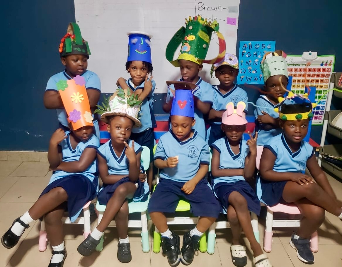 Students wearing handmade creative hats in the classroom