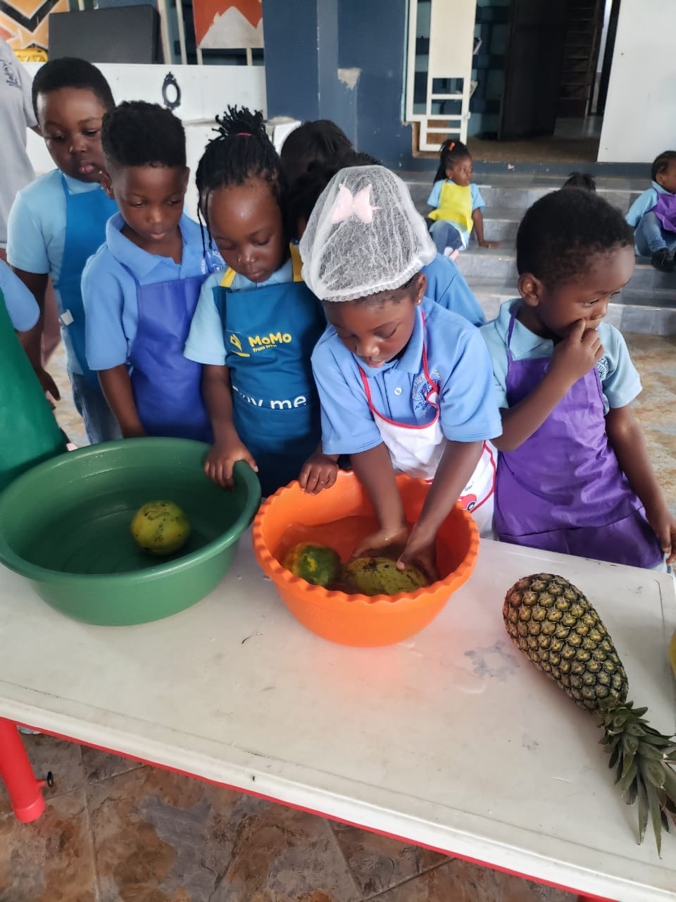 Two teachers and students celebrating with smoothies and food