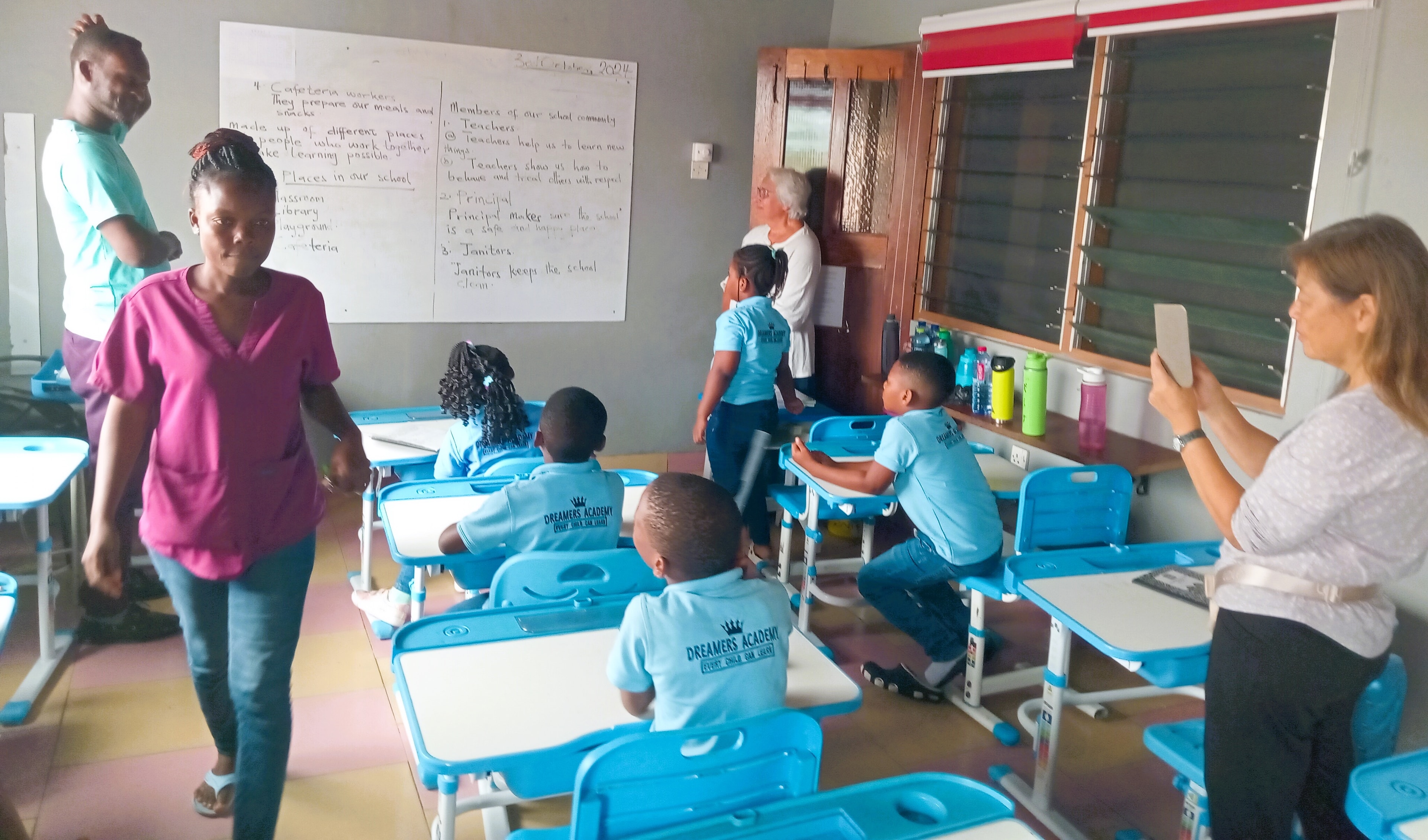 Teacher giving a student a high five in the classroom