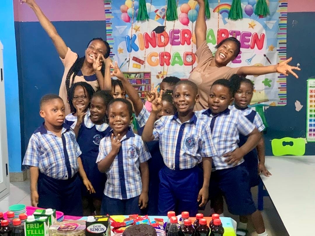 Teachers and kindergarten graduates celebrating in the classroom