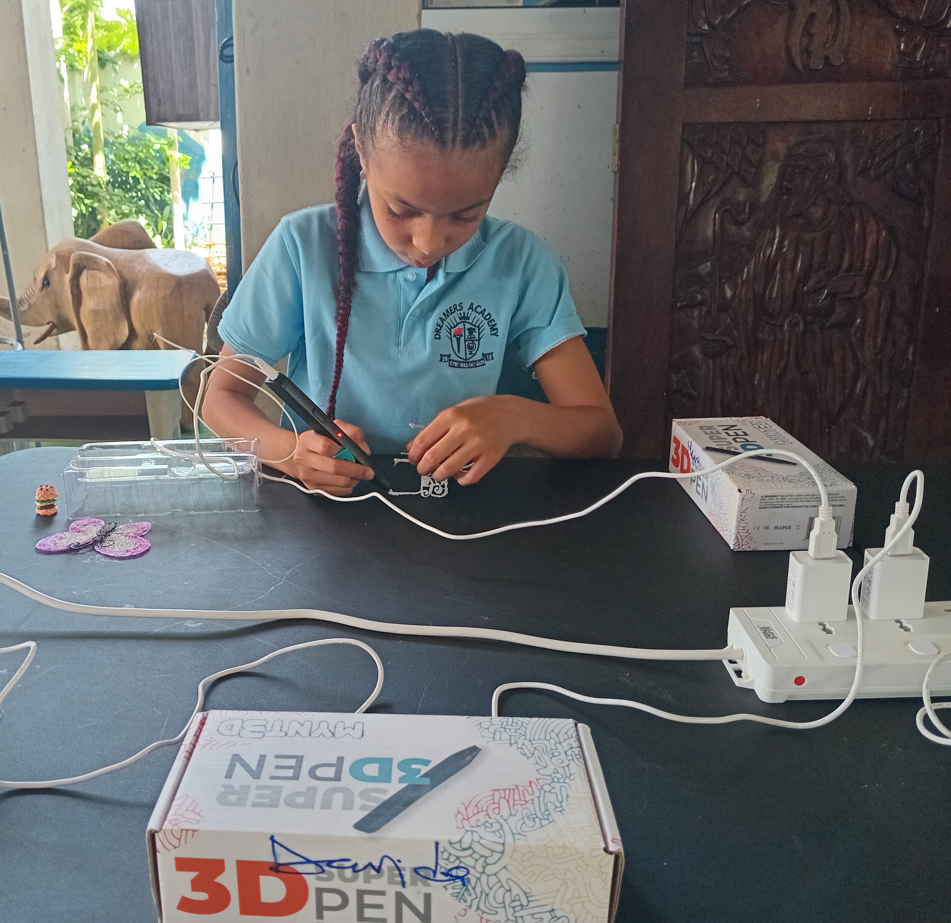 Teacher helping a student with an engineering challenge