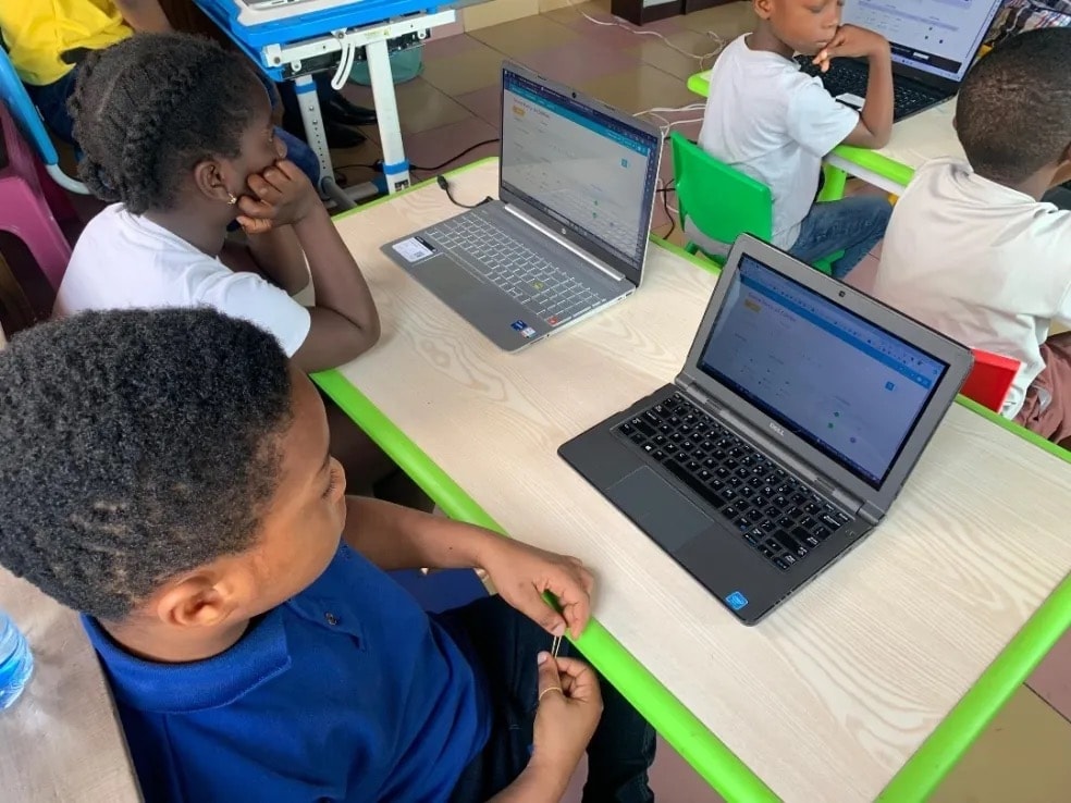 Students working on laptops in a technology class at Dreamers Academy-GH