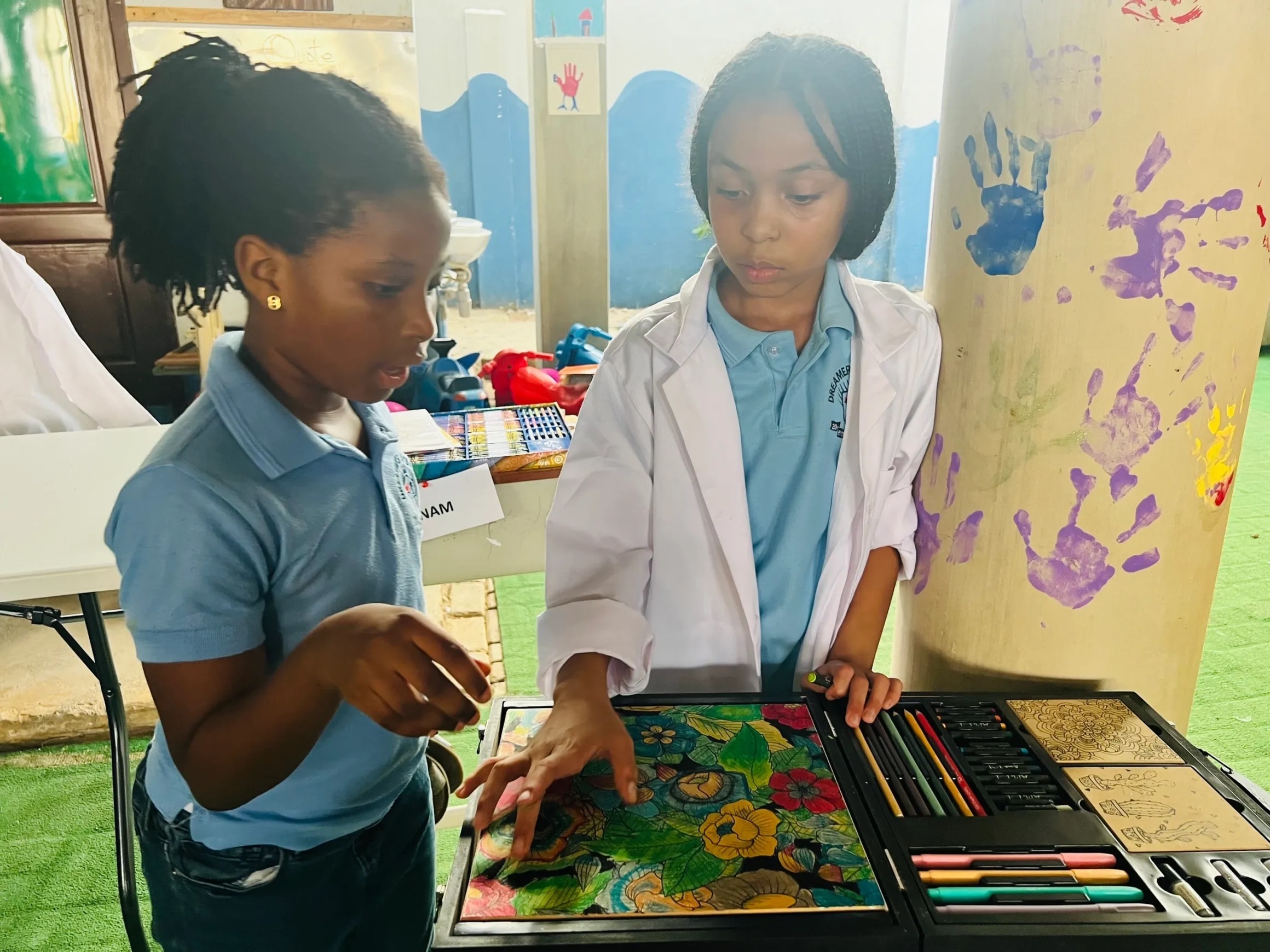 Two students collaborating on an art project at Dreamers Academy-GH