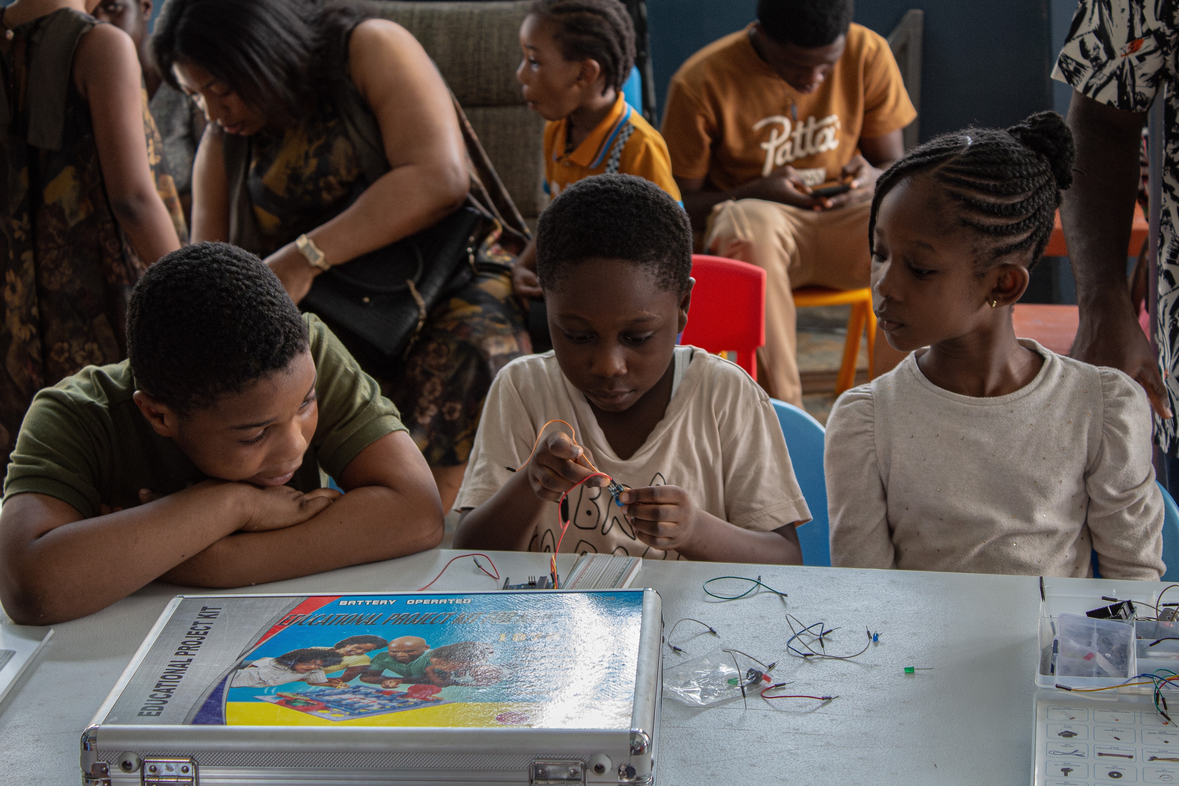 Children building electronics circuits at a STEAM fair